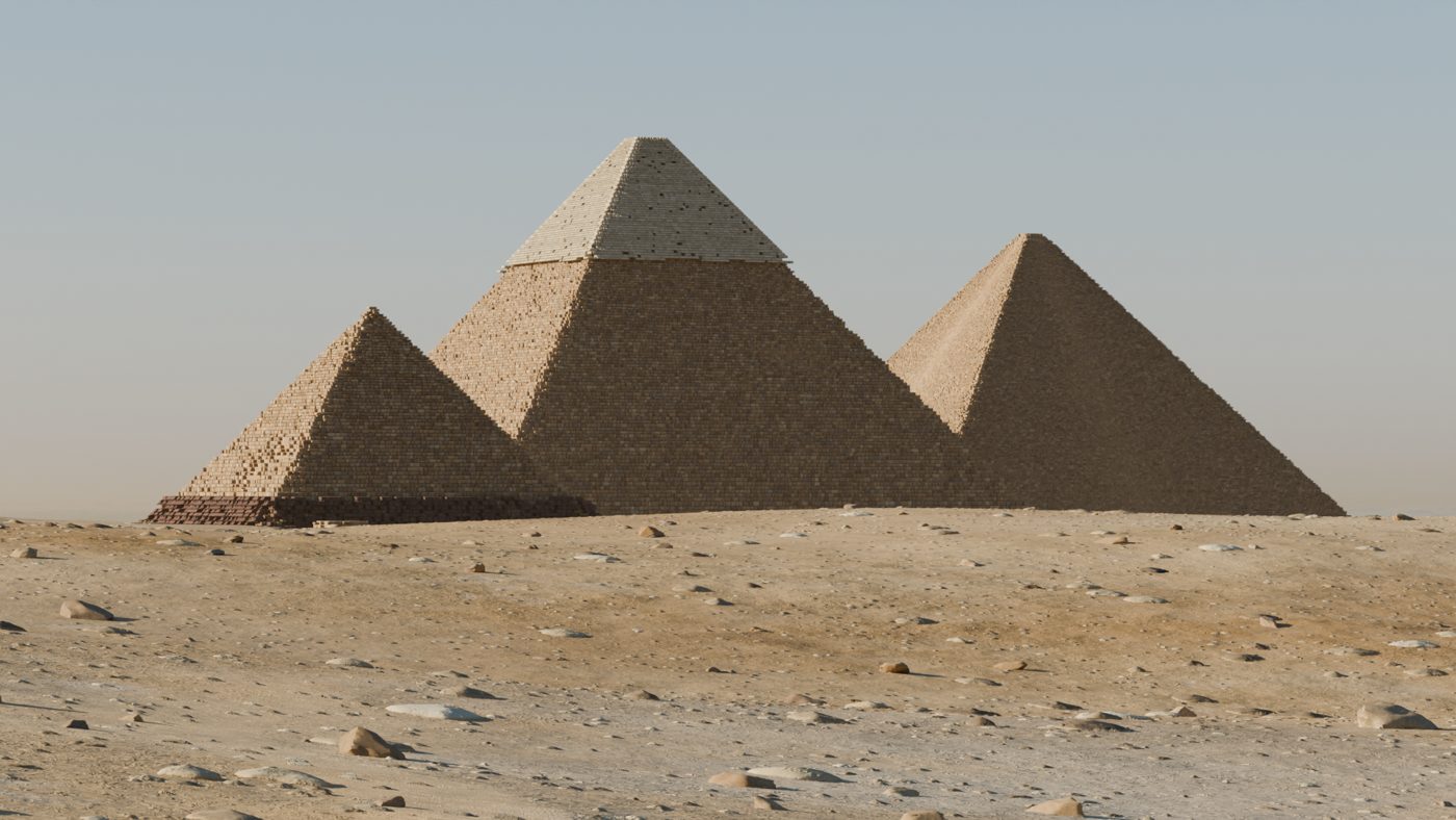 The pyramids stripped of most of their casing, with sand drifted around them.