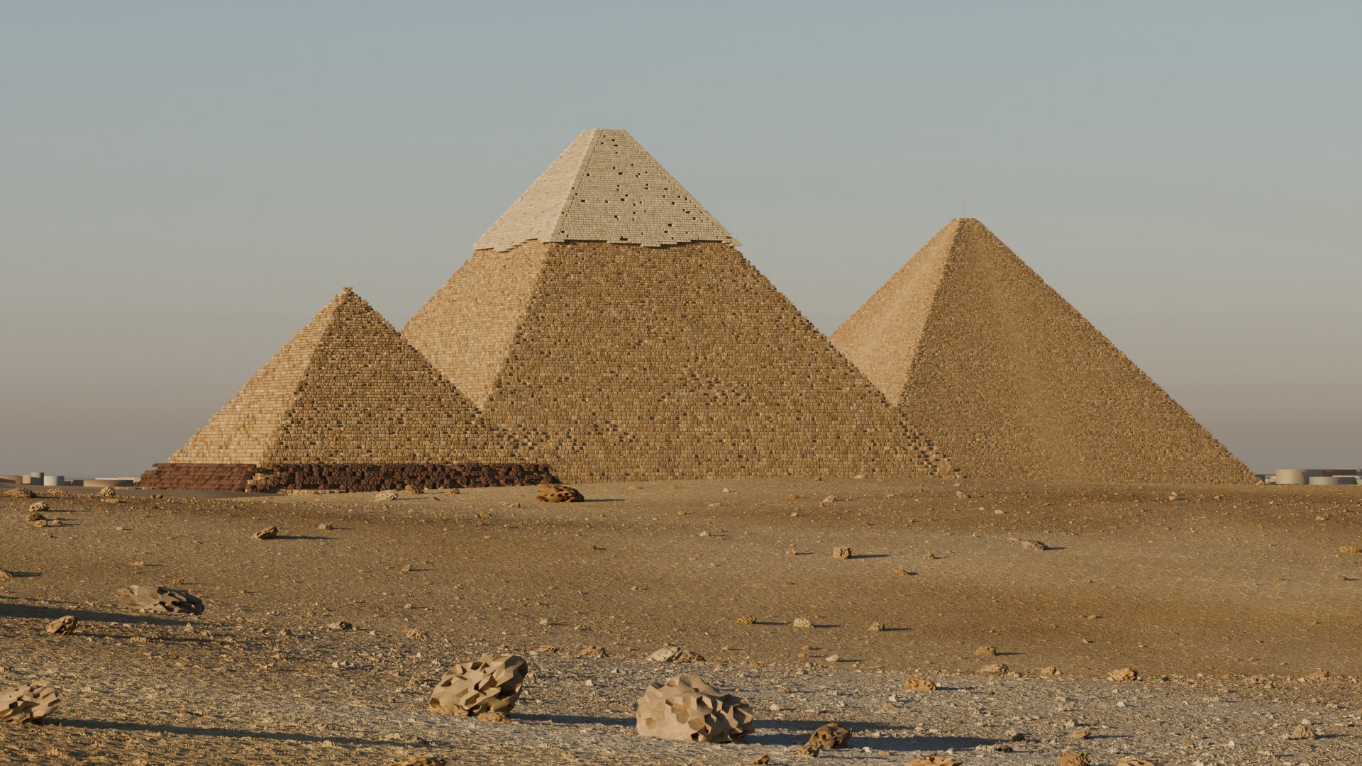 The three pyramids today, stepped and weathered, at golden hour.